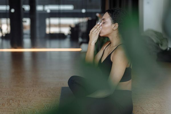 Woman in a peaceful yoga pose, embodying mental clarity and strength.
